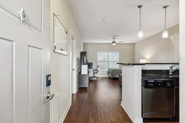 kitchen with baseboards, a ceiling fan, dishwasher, dark wood-style floors, and a sink