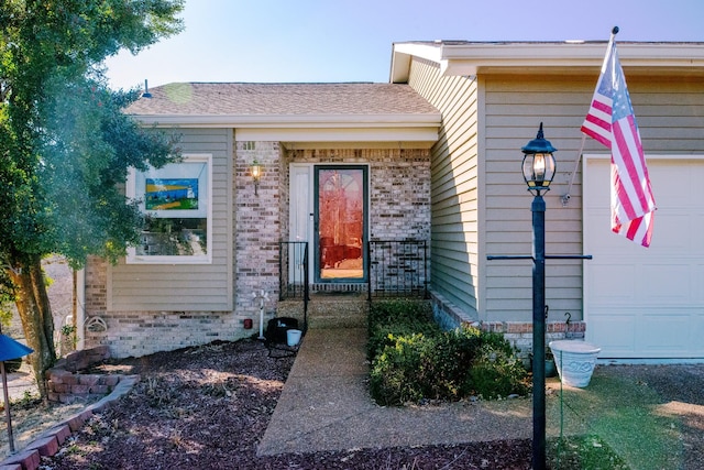 doorway to property with a garage