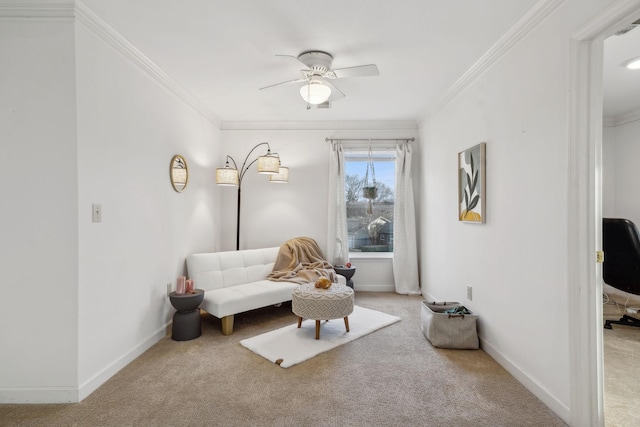 sitting room featuring carpet floors, ornamental molding, and ceiling fan