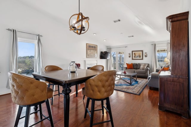 dining area featuring dark hardwood / wood-style floors and a chandelier