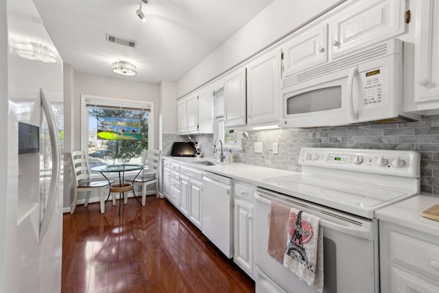 kitchen with white cabinetry, sink, backsplash, and white appliances