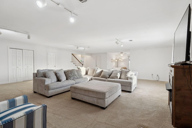 living room with light colored carpet and rail lighting