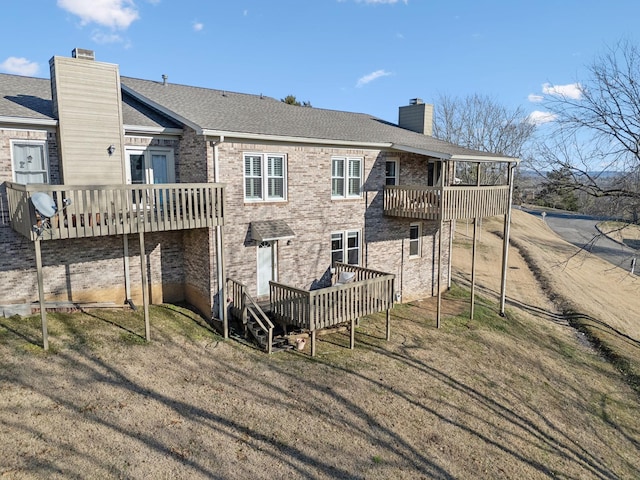 back of house with a wooden deck and a yard