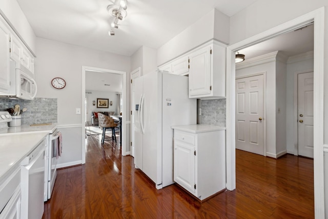 kitchen with dark hardwood / wood-style flooring, white cabinets, white appliances, and decorative backsplash