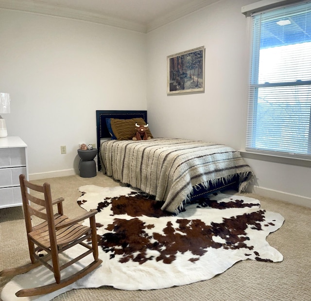 bedroom featuring ornamental molding and carpet floors