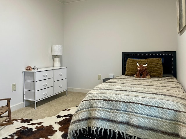 bedroom featuring light carpet