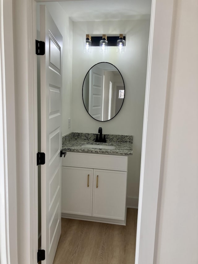 bathroom featuring hardwood / wood-style flooring and vanity