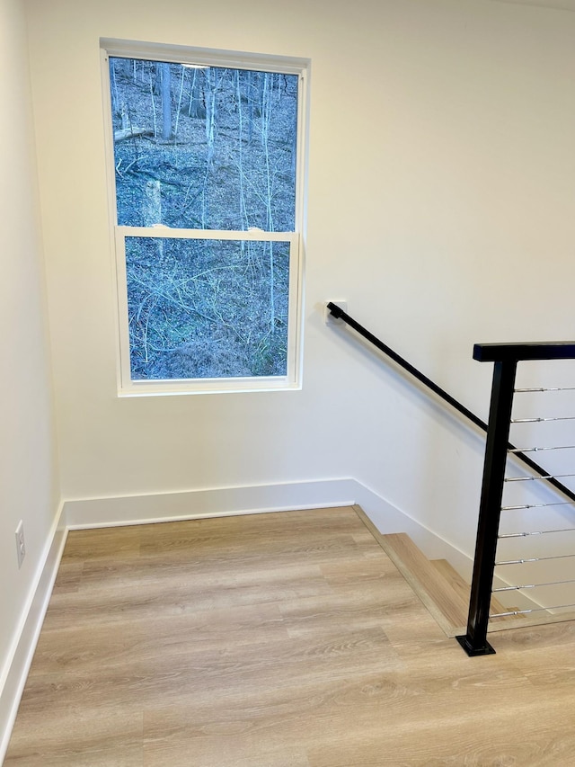 stairway with hardwood / wood-style flooring