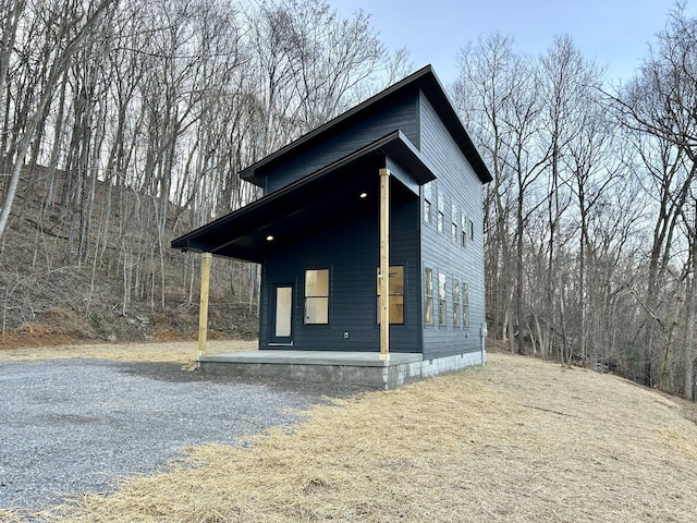 view of side of home with covered porch