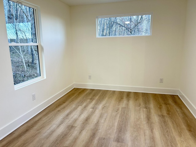 unfurnished room featuring light hardwood / wood-style floors