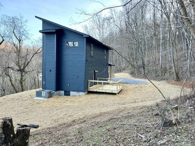 view of side of property featuring central AC and a deck