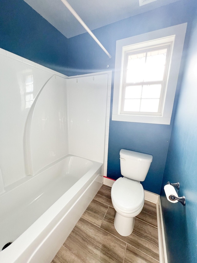 bathroom featuring toilet and  shower combination