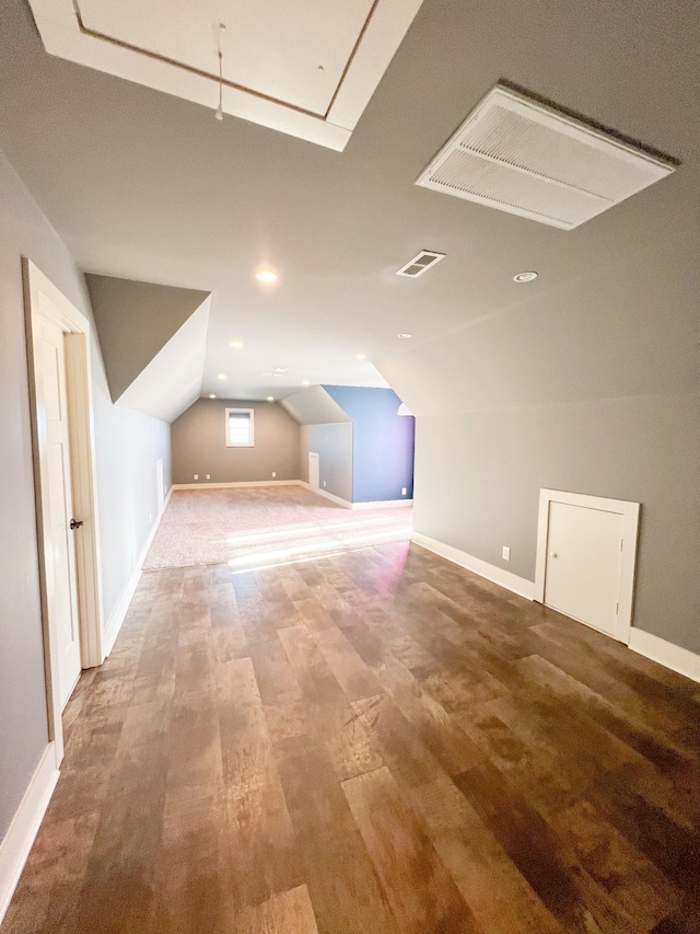 additional living space featuring vaulted ceiling and wood-type flooring