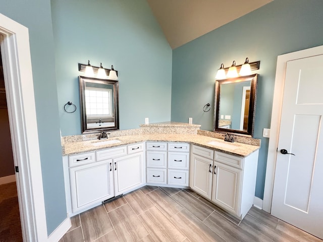 bathroom featuring vanity and vaulted ceiling