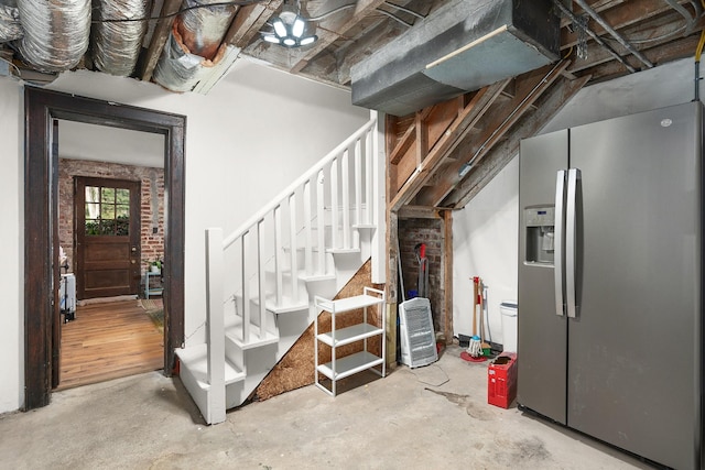 basement featuring stainless steel fridge