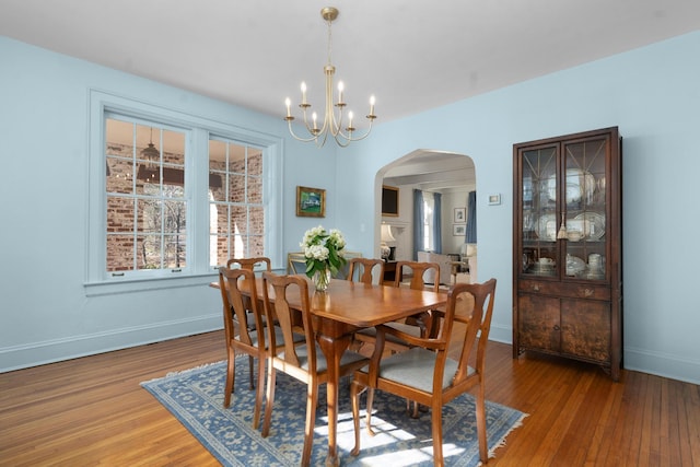 dining space with a chandelier and wood-type flooring