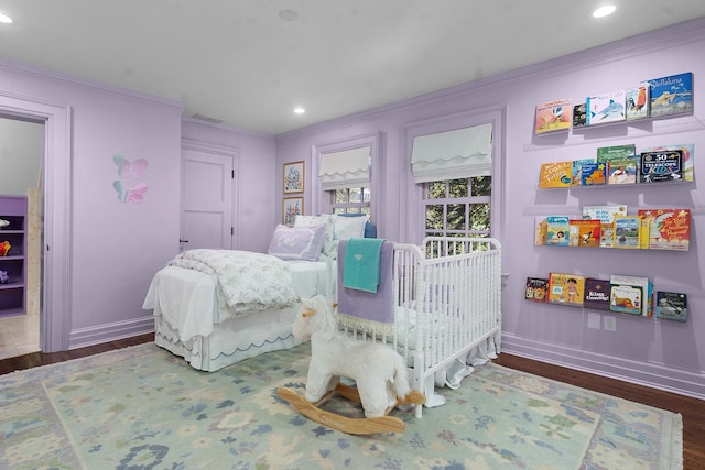 bedroom featuring dark hardwood / wood-style floors and crown molding