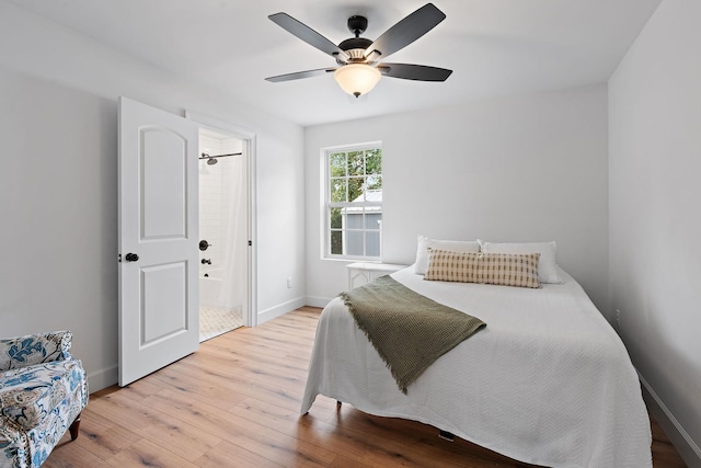 bedroom with ceiling fan, light hardwood / wood-style floors, and ensuite bath