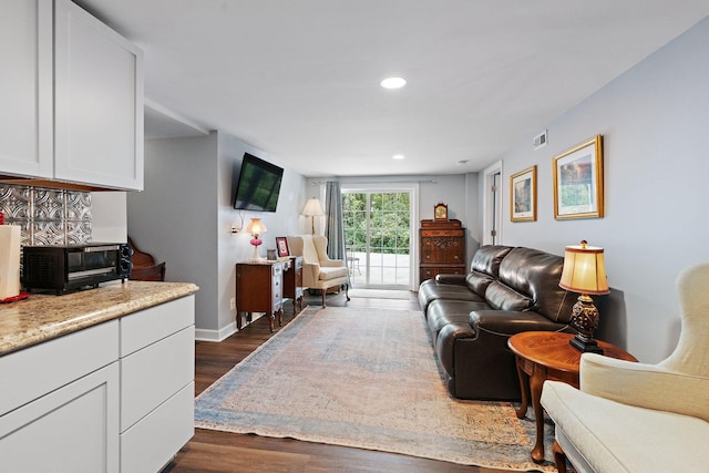 living room featuring dark wood-type flooring