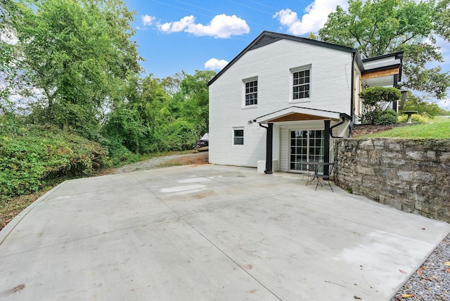 rear view of property featuring a patio area