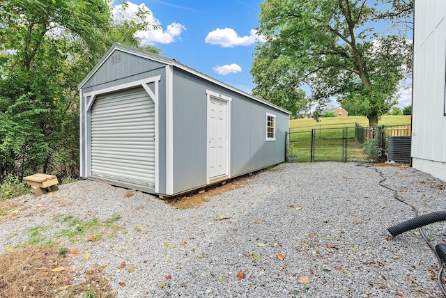 view of outdoor structure with a garage and central AC