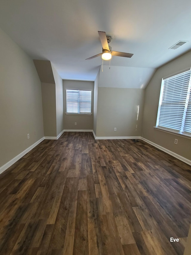 bonus room featuring lofted ceiling, dark hardwood / wood-style floors, and ceiling fan