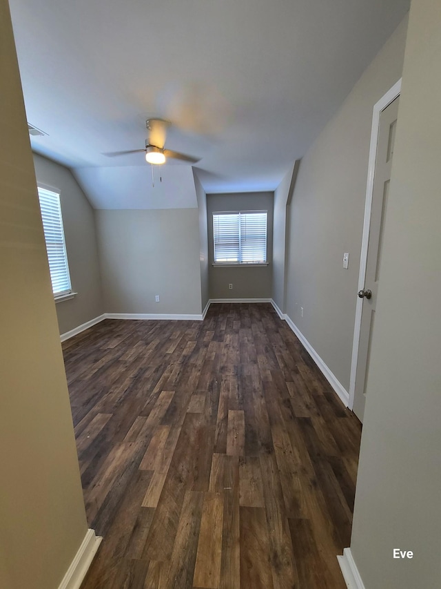 unfurnished room featuring lofted ceiling, dark hardwood / wood-style floors, and ceiling fan