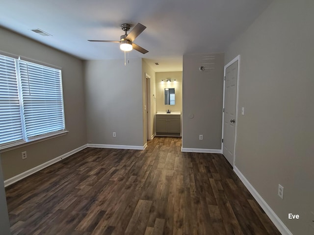 spare room featuring dark wood-type flooring and ceiling fan