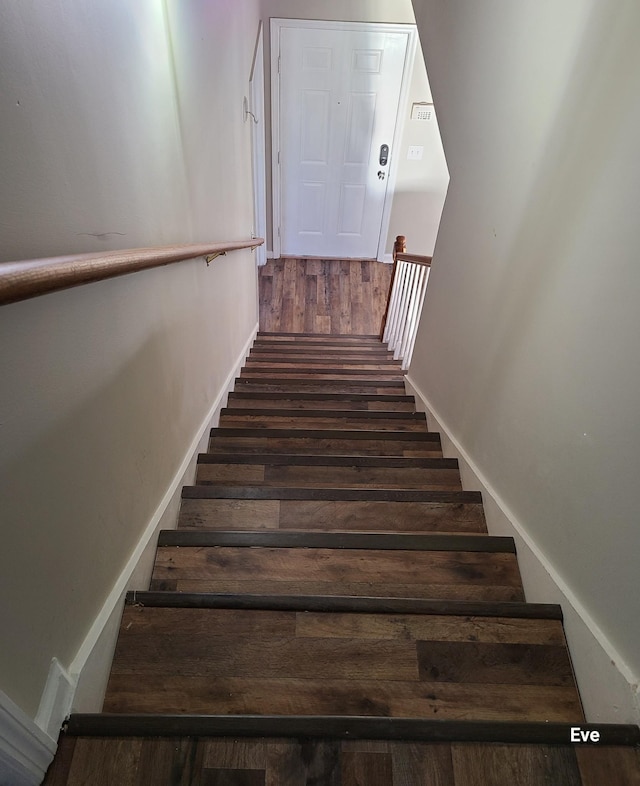 stairs with hardwood / wood-style floors