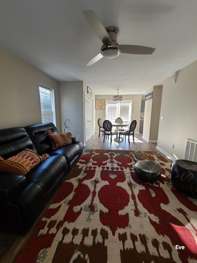 living room with a healthy amount of sunlight, hardwood / wood-style floors, and ceiling fan