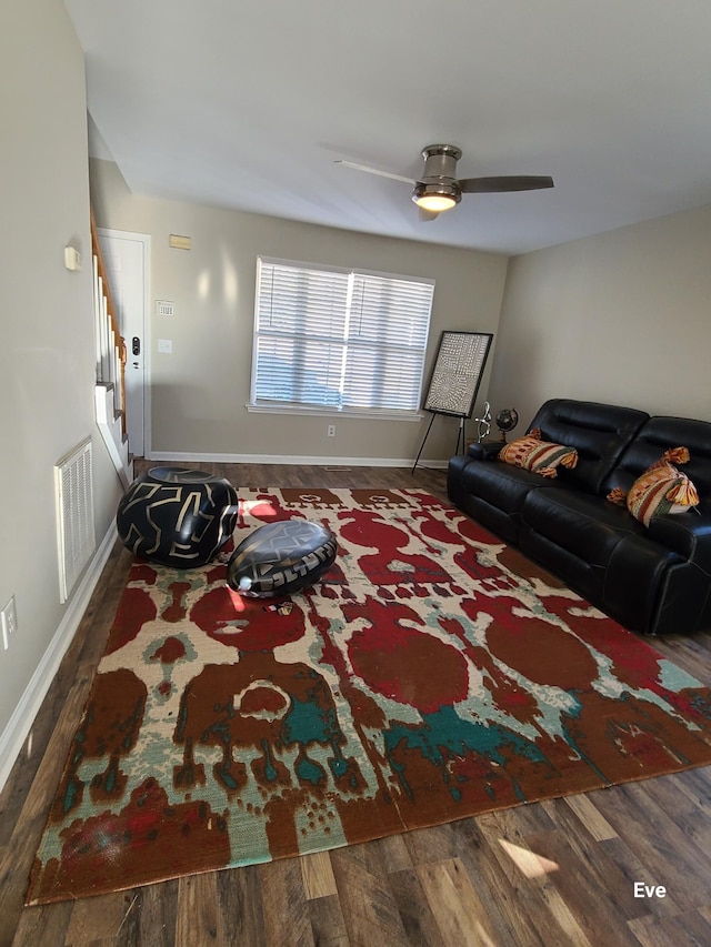 living room with dark wood-type flooring and ceiling fan