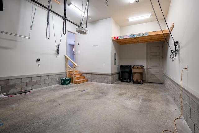 garage with electric panel and a garage door opener