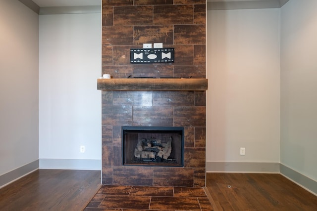 interior details with a tile fireplace and hardwood / wood-style floors