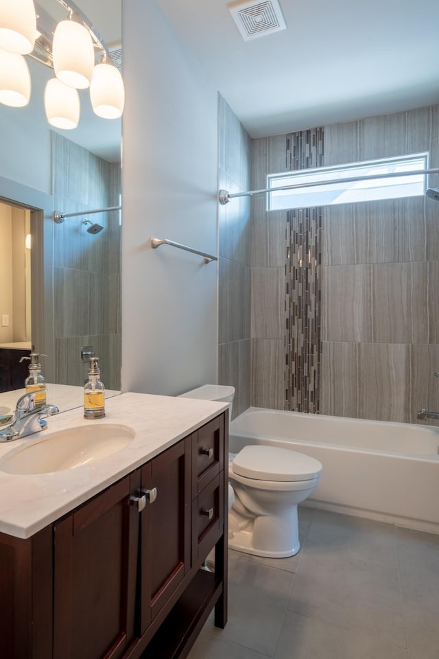 full bathroom with toilet, vanity, tile patterned flooring, and tiled shower / bath combo