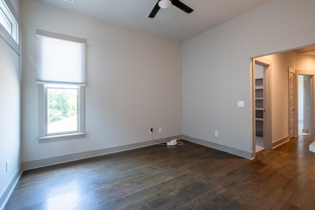 unfurnished room with ceiling fan and dark hardwood / wood-style flooring