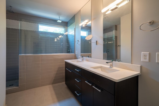 bathroom with vanity, tile patterned floors, and tiled shower