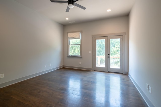 spare room featuring french doors, ceiling fan, and dark hardwood / wood-style floors