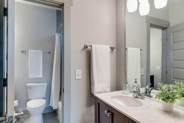 bathroom featuring toilet, tile patterned floors, shower / bath combo with shower curtain, and vanity