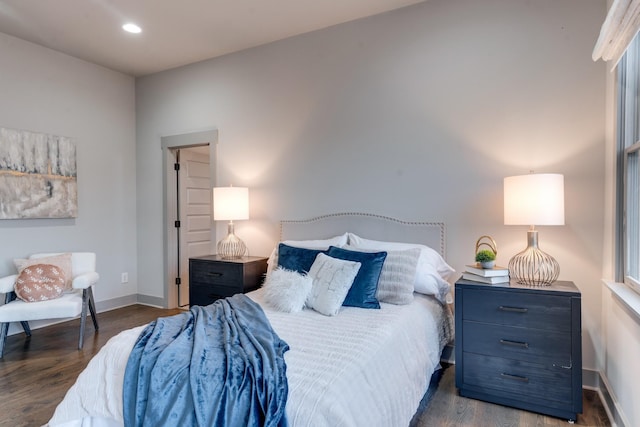 bedroom featuring baseboards, wood finished floors, and recessed lighting