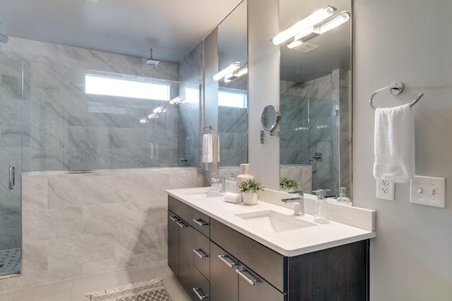 bathroom featuring a sink, a shower stall, and double vanity