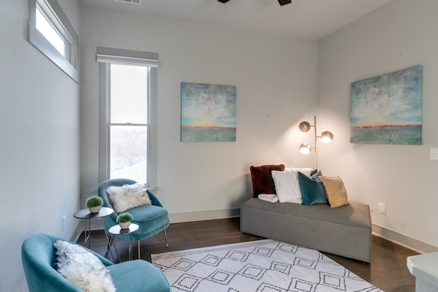 living area featuring baseboards and wood finished floors