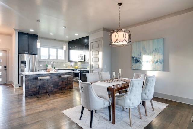 dining space with dark wood-style floors, recessed lighting, and baseboards