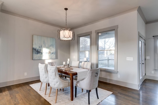 dining room featuring wood finished floors and baseboards