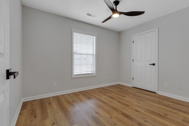 spare room with light wood-type flooring and ceiling fan