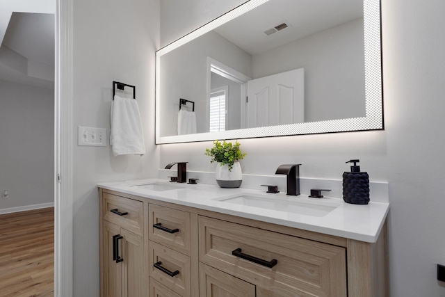 bathroom with hardwood / wood-style floors and vanity