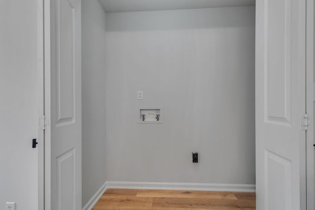 washroom with hardwood / wood-style floors and hookup for a washing machine