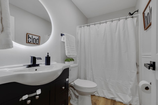 bathroom with hardwood / wood-style floors, vanity, and toilet