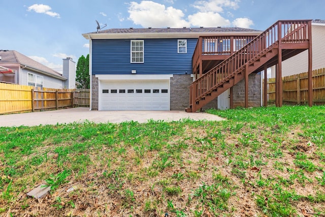 back of property with a garage