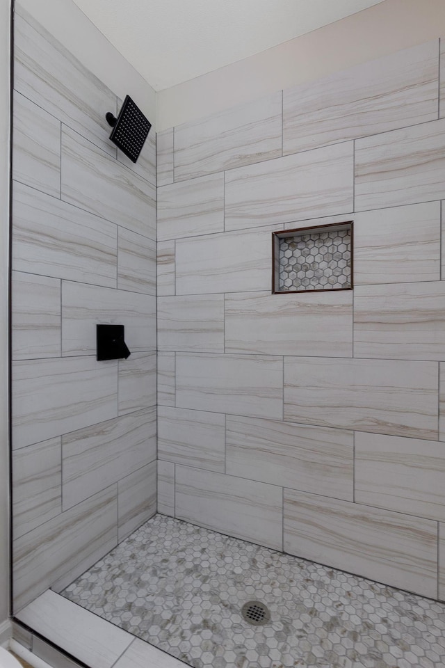 bathroom with a tile shower