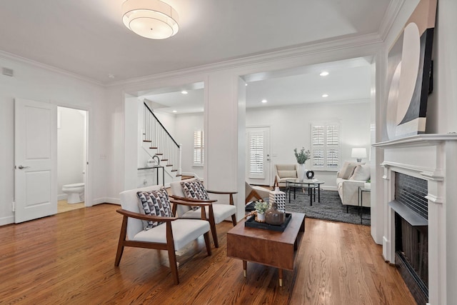 living room with hardwood / wood-style flooring and crown molding